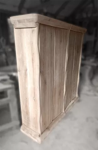 Bespoke freestanding wine rack made of solid oak featuring organic curved front panels and rustic finish.